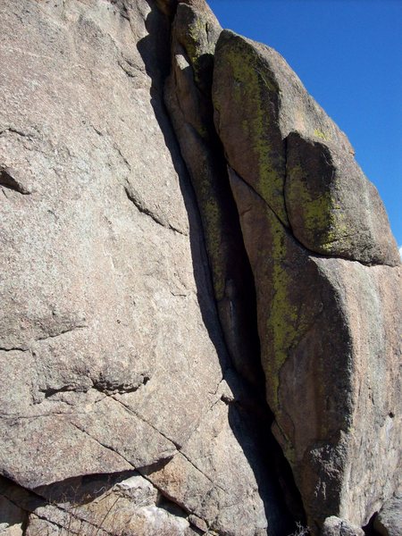 5.8 Dihedral on the NW face.  Gear fingers to hands. Bolted anchors. ~ 50'.