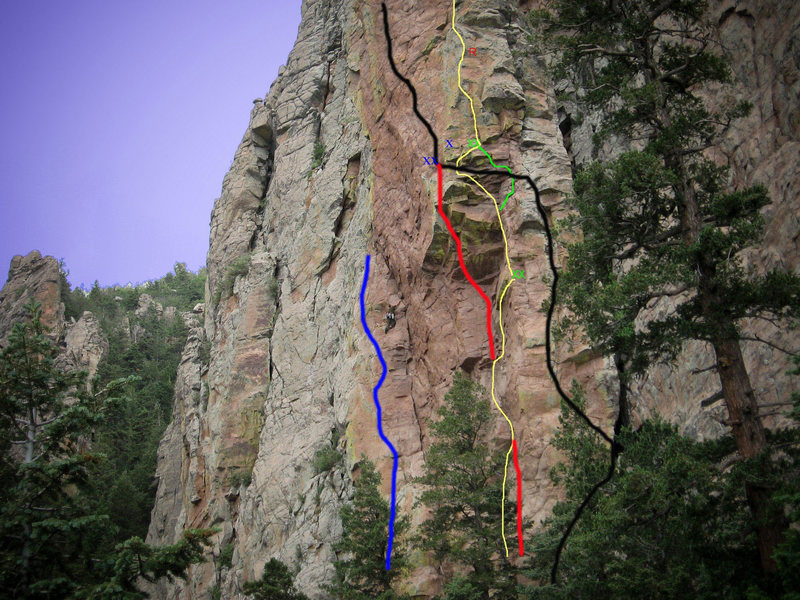 Photo topo of Bush Shark Spire.<br>
Blue Line is Feeding Frenzy 5.10<br>
Climber is on the Bush Shark Spire Route 5.9<br>
Yellow Line is Mudshark App.. 5.11+ R<br>
Red Line is Great White 5.13<br>
Black Line is Hammerhead 5.12-