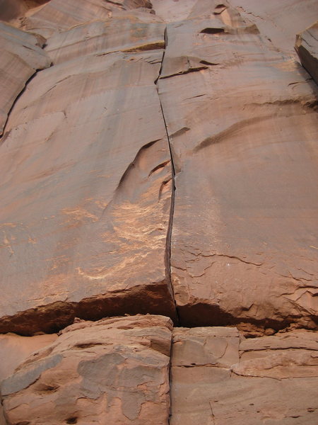 The route begins a few feet below the bottom of the photo will easy 5th class climbing to gain the crack.