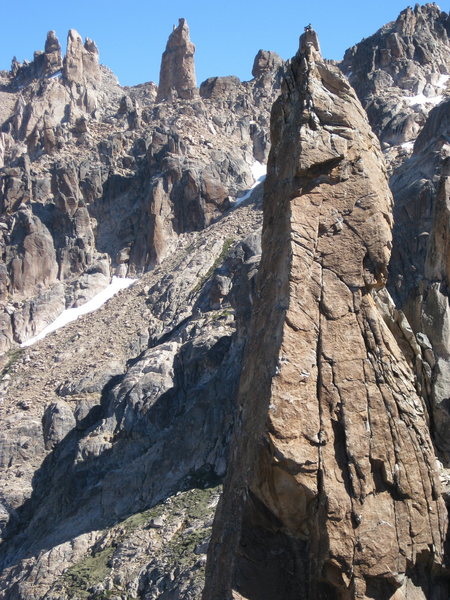 Del Frente climbs up the shaded face on the first pitch, then the sharp arete that's in the sun for P2.  You can barely make out two climbers on the summit.  Photo by Chelsea Morgan