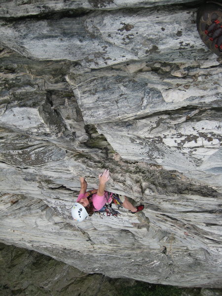 Elyse climbing on tiny holds above the roof...