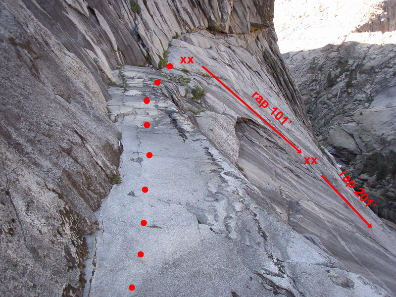 Photo showing the "cat walk" prior to the rap. It's short, easy walk to get to the rap station. First rap is 100'. Second rap is about 200'. I suspect you could do the 2nd rap at 100' and downclimb the rest on ledges to the right of the rap line. Careful not to rap off the end of your rope!
