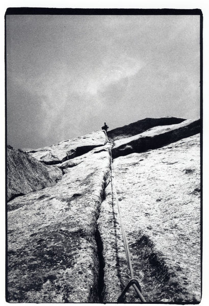 Climber on the fist crack seen from the belay