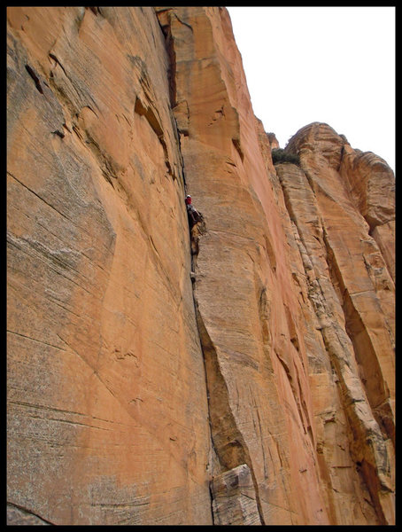 Joe Garcia passing the second roof of P1 on The Golden Spike in Sedona, AZ.