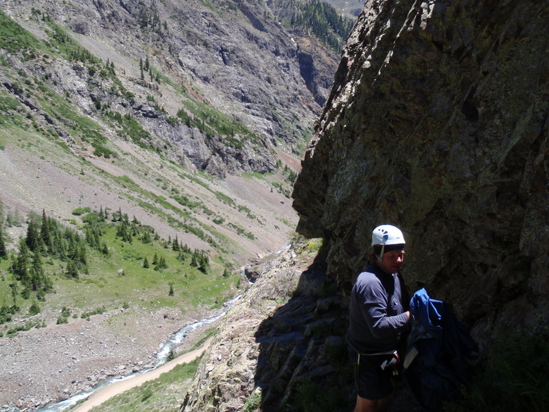 Climb starts from where I'm standing. The 5.9 is on the other side of the bulge behind Jeff. (Background: Looking down the canyon towards Eureka. The intermittent waterfalls which form the classic ice climb, Stairway to Heaven, can be seen across the valley.)
