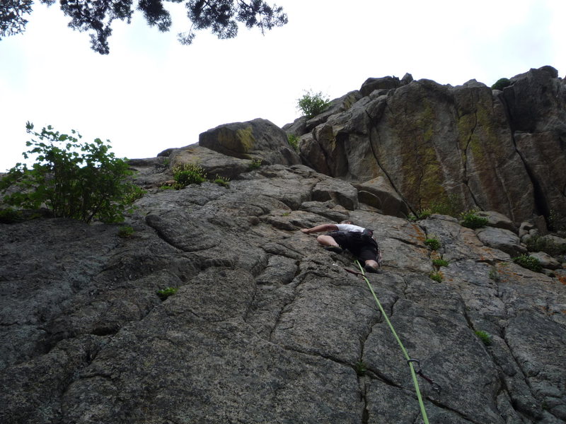 On the slab above the second bolt.