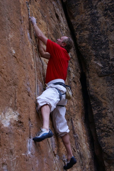 John Bachar on Stealin.  Martial Arts pants rolled to the knees, ultra light biners, super light harness with belay loop cut off, chalk bag with lining ripped out, something red and Acopa Merlin shoes. It didn't matter if it was 5.6 or 5.12, always the same.