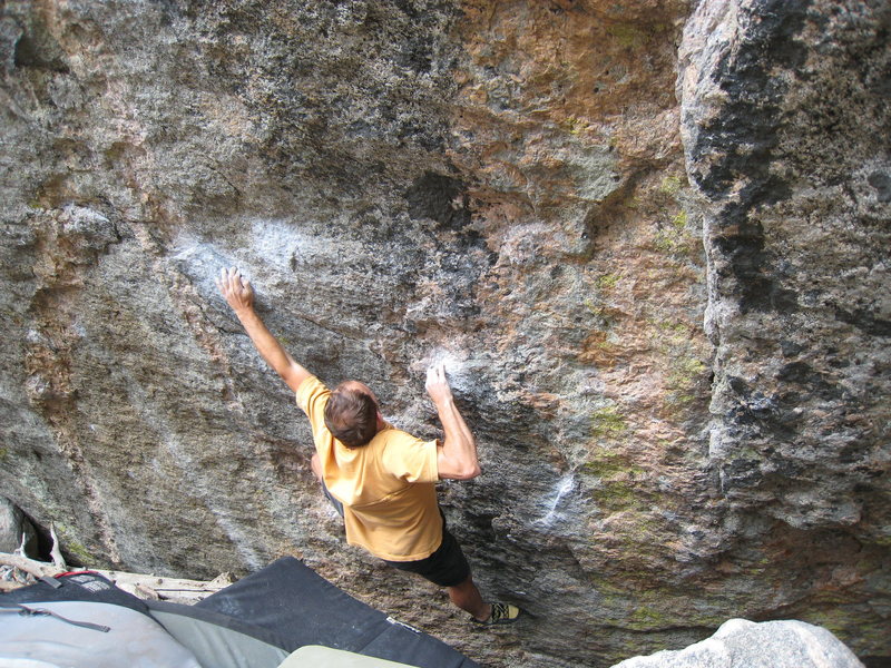 The shouldery crux move of the Dali SDS. The problem begins matched on the chalked sidepull down & right of the climber's right elbow.