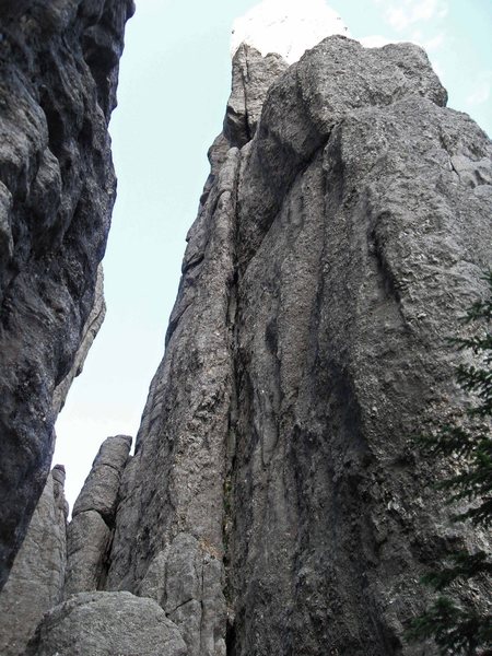 Looking up the squeeze chimney on Pitch 1 to the ledge above.
