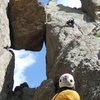 Lenore Sobota belaying Paul Huebner. The 1st anchors are just above and below the huge chockstone. (Photo by Anne Meyer)