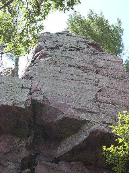 TM goes straight up the main crack to the ledge. A direct version heads right at the good horizontal before the roof and straight up the face.