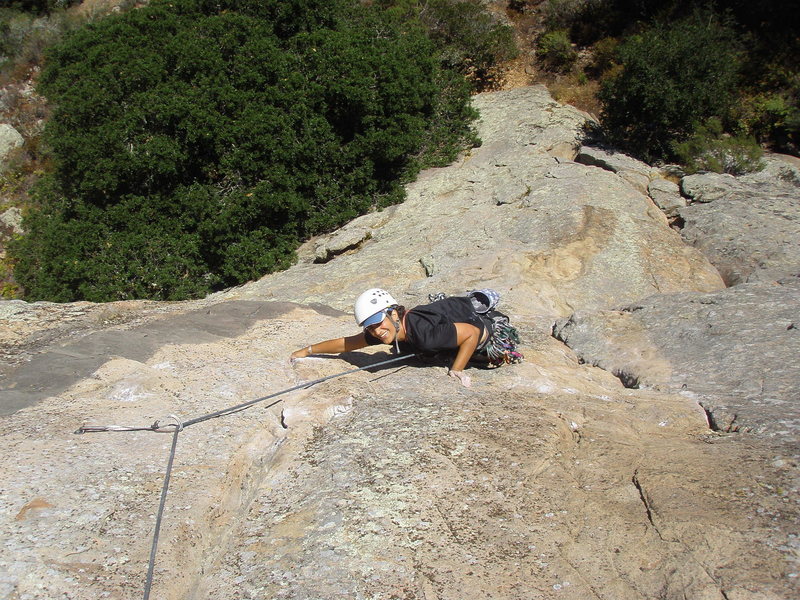 Vickie grabs the lower rail at the crux of the climb. Leaving the crack & finding the lower rail is the key to this climb.