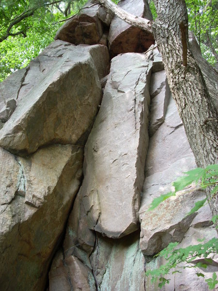 The overhanging inside corner crack is "R.C." 5.10c.<br>
The crack to the right is "Outside R.C." 5.10d.