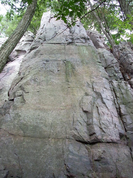 This face is "Bread Board" 5.10b and can be found down and around the corner to the north of "K2" or "Special K".