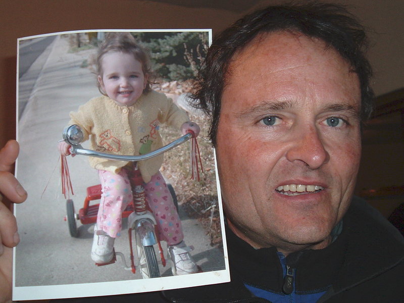 Craig with his daughter, Guilia's picture. Craig always put up pictures of her all around his bed when he traveled. He missed her so.
