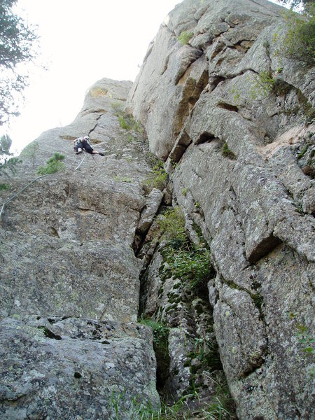 Hollow Man climbs the crack/flake and arete above on the left of the mossy dihedral. Vrainavore 10a is the crack system on the right. Handcrack-a-rete is just out of sight on the right side of the photo.
