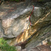Start with your hands on the two chalky holds in the horizontal and climb up the vertical crack and face to the top out
