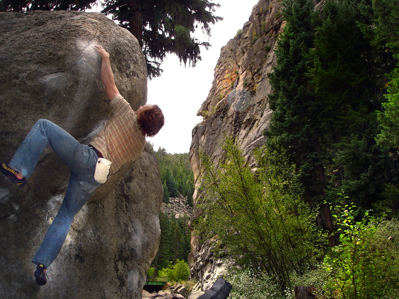 Luke Childers slapping his way up the "Standard Bulge" on the "Castle Rock Cube" A.K.A. the "Citadel Boulder" near the "Castle Rock" formation. Boulder Canyon, Colorado.