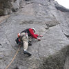 Lenny Miller cruises the crux finger-tip lieback on pitch 3.
