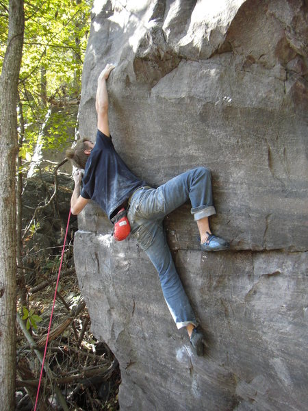 Making the long reach after sticking the crux move.