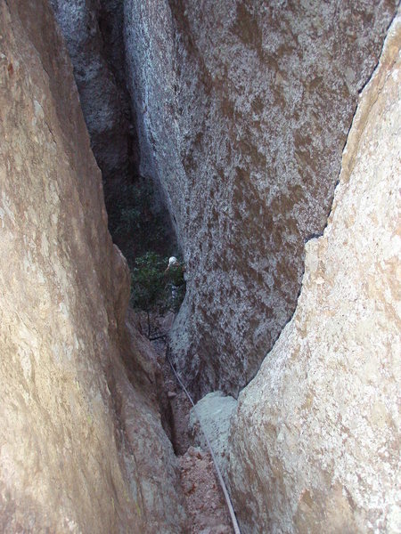 Looking down the waterchute/chimney at the top of Pitch 4. The crux 5.8 move is right at the bottom and is well protected.