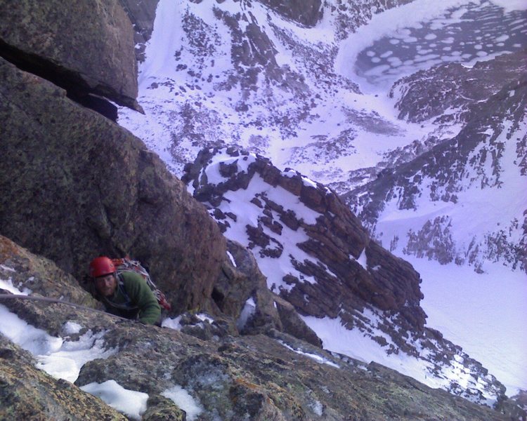 Chris Reinholt following the third pitch of Zumie's Thumb on 11-7-09, with Lamb's Slide and Chasm Lake down below. Photo by Chris Sheridan.