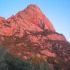 Profile of south face, with the Southeast Arete (5.6) in profile on the right.  Bathed in the light from the setting sun.