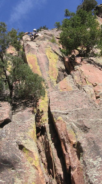 Pitch 1 begins in this unattractive crack. The rock quality and the climbing gets better once you move around the horn, where the climber is in this photo.<br>
(Photo by Lenny Miller.)