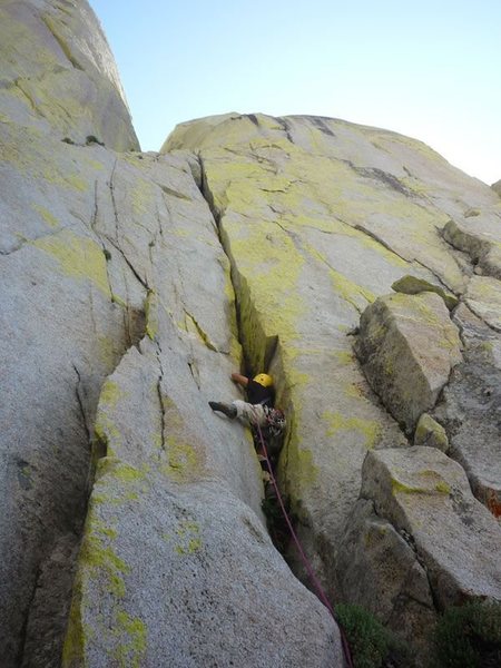 Starting up the steep crack to gain the large chimney of The Sarcophagus