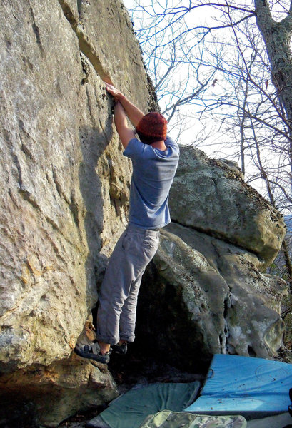 Aaron Parlier with the fa of "Domain" (V-4). Maxima Boulder. Bluefield.