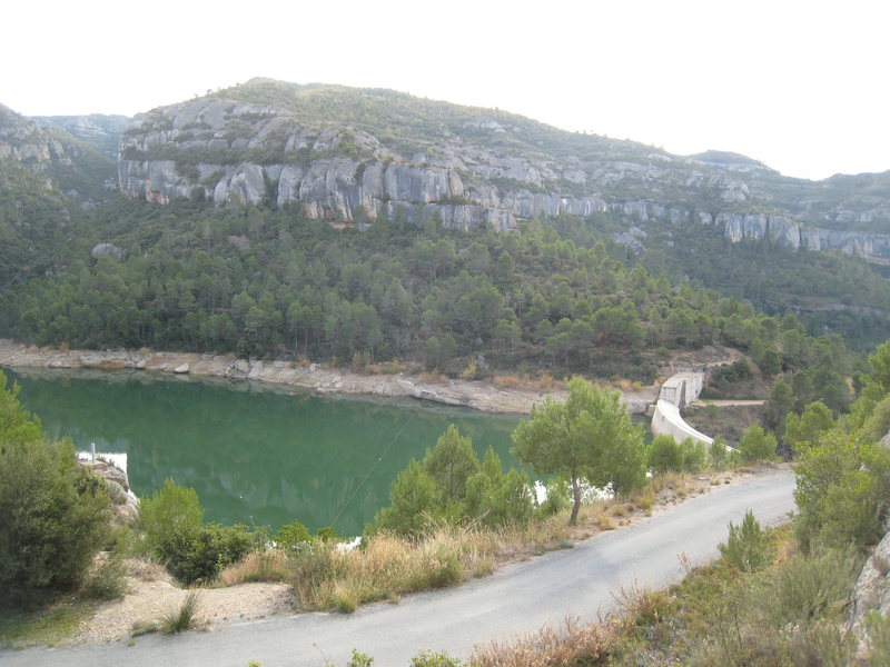 The "Embassement". There is free camping below the damn. The large cliff just left of center is "Ca La Morta" (with 30 or so routes 12a & under). "Culampe 4", home to one of Margalef's best 12a's, is the largest block on the right.