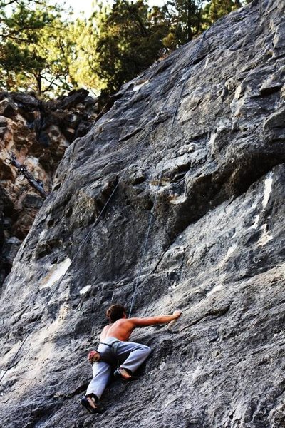 Man climbing "Black Sheets of Rain"