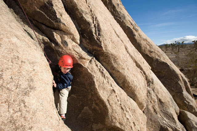 Three-year-old Bryson Fienup climbs on Trashcan Rock, in Joshua Tree National Park.