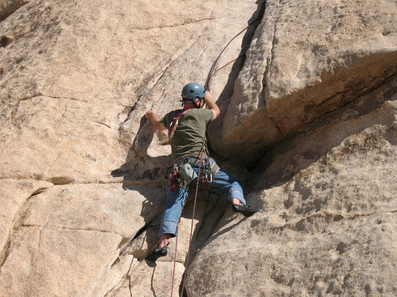 Retrieving a stuck rope near the crux move of The Bong. My left hand is on the flake that makes the move go at 5.4