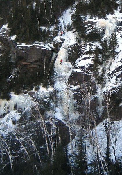 Dogleg Right with a person at the tree belay and on the upper section of the route.