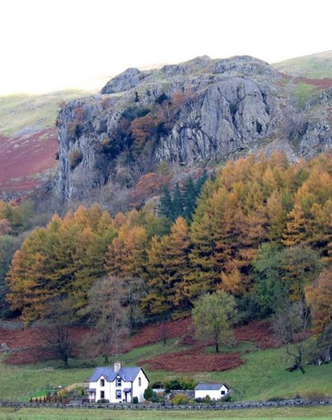 Looking up from the road to Castle Rock of Triemain. Climbers are visable on the right of the South Crag,with the steep North Crag to he left. Photo Dave Richardson