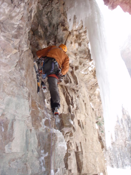 A miner in a hole with "White Gold". Headed up onto the free-hanger, on the start to Left Corner of Hidden Falls. The pin is just above my left shoulder, straight up in the roof.
