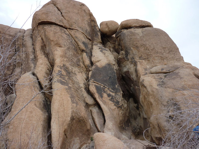 The deep brown chimney with the large chockstone on top is Eyesore.