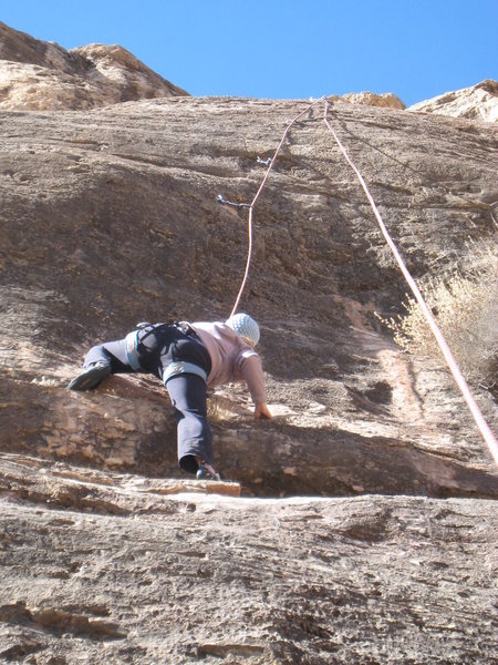 Surmounting a low bulge. The crux hits with a vengeance at the second draw above the climber.