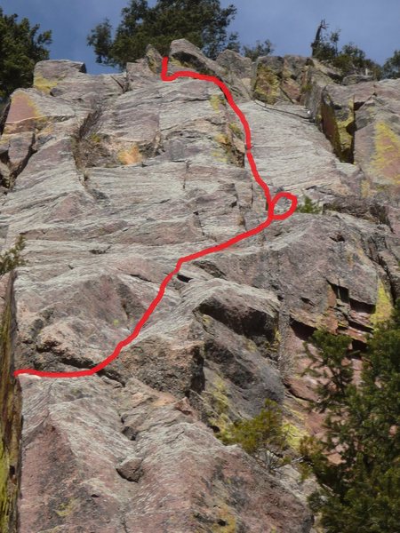 Red line shows the route from the traverse at the horn on the first pitch to the top. First belay is circled.