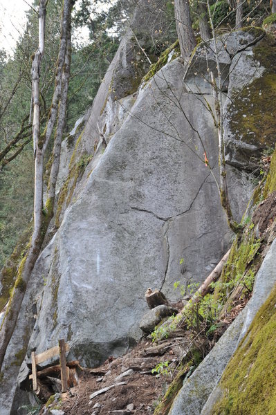 Starts on the thin face crack, traverses left to the arete where the angle kicks back. The direct start is 'Midget Love', 5.12.