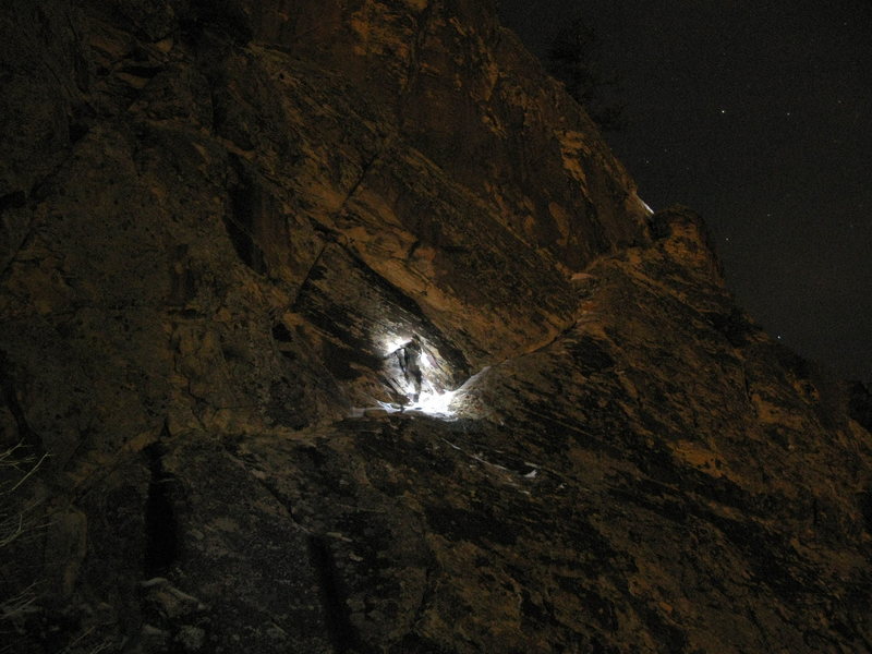 Roman "shadow warrior" doing the final 4th class traverse - totally covered in black (and white) ice - at night, illuminated by the glow of vegas and the nervous gaze of our headlamps