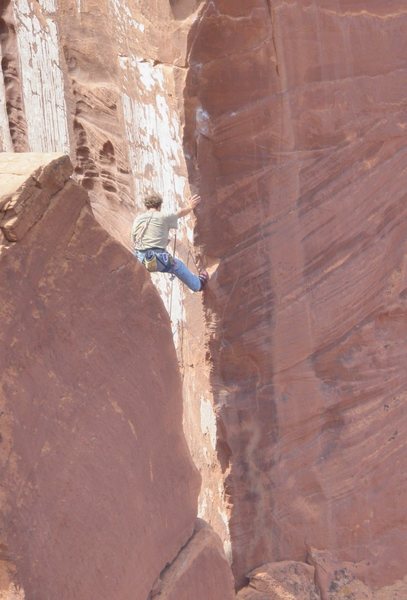 Nico leading pitch 3; just before stepping across onto the arete