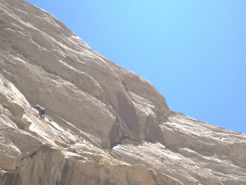 Climbing onto belay ledge. The climb Rat in the Hat continues up the falt line to the right