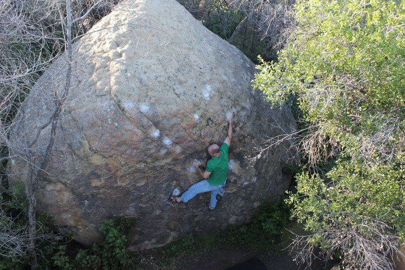 I am climbing Sasquatch in this photo, which continues straight up from where I am. Yeti begins just above my right foot and follows the well-chalked holds up and left to an exciting top out at the high point of the boulder.