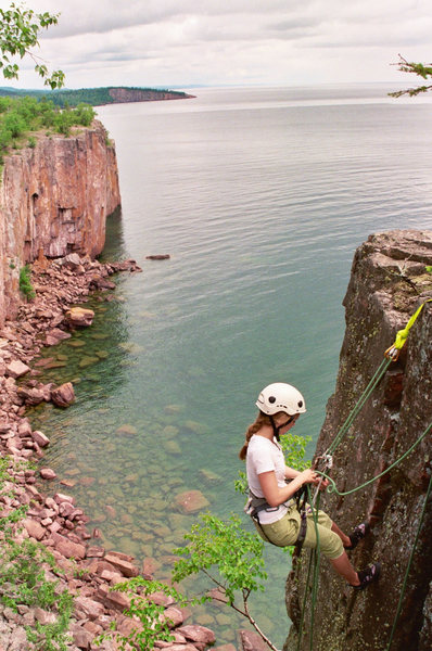 Claire Daley rappelling in to take on some offwidth 