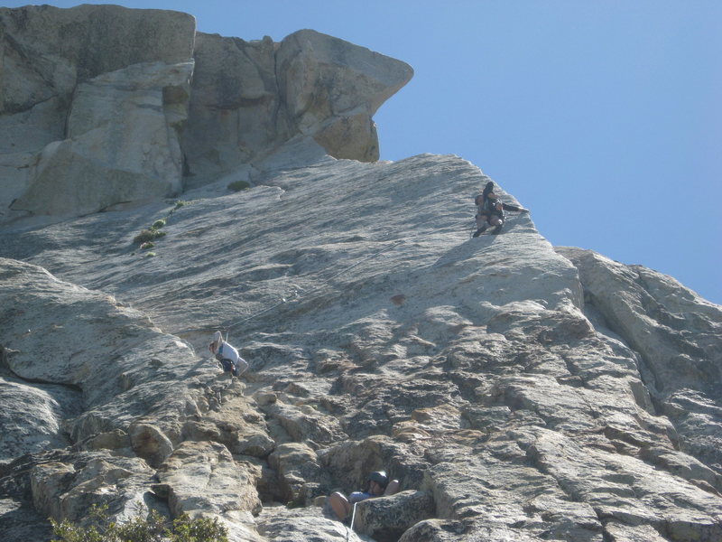 Agina setting up a belay on pitch 1 with climbers on the edge route above her. 6-26-10
