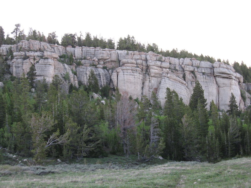 Gun Street from the approach trail. In the center of the photo is the shorter Gun Street Wall and the far right is the Cowboy King Wall with double bulb roof that contains American Beauty. The leaning block in the middle contains two 5.10's.