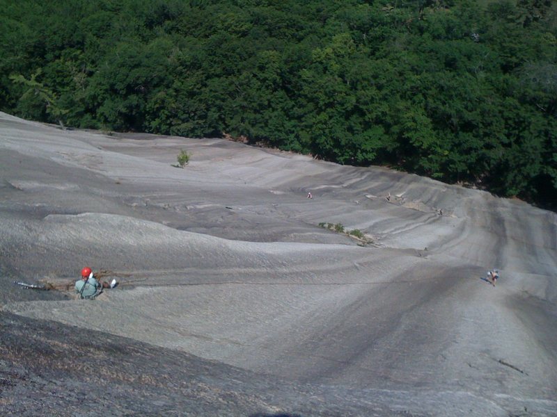 A party of two in the third pitch of Sliding Board, as seen from the route Wedge. One can also see two other parties starting Standard Route far below.
