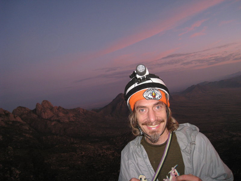 Bob A. as the sun rises near the end of our full moon climb, Sept 5-6, 2009. (pitch 10 belay?)